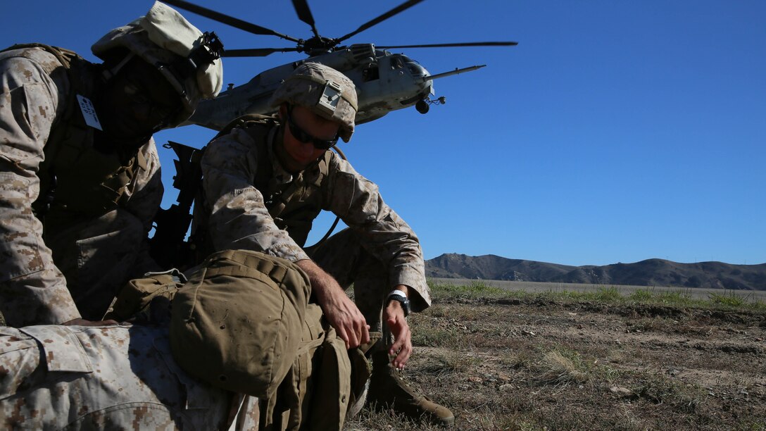 Petty Officer First Class Anthony Paschal, left, and Cpl. Scott Rassner, both members of Combat Logistics Battalion 13, the logistics combat element for the Boxer Amphibious Ready Group and 13th Marine Expeditionary Unit, provide medical attention to a simulated casualty during a non-combatant evacuation operations at Marine Corps Base Camp Pendleton, California as part of Composite Training Unit Exercise, Oct. 23, 2015. COMPTUEX provides the MEU ARG the opportunity to integrate naval training while also allowing focused, mission-specific training and evaluation for the Navy-Marine Corps team. (U.S. Marine Corps photo by Sgt. Paris Capers/ RELEASED)