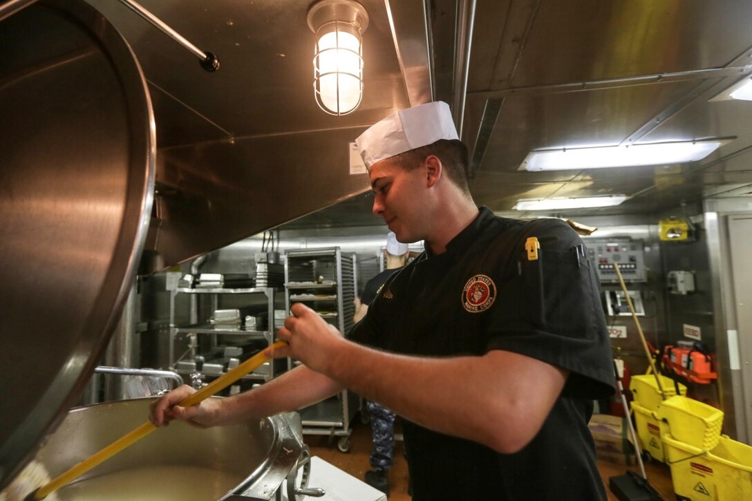 GULF OF ADEN (Oct. 29, 2015) U.S. Marine Cpl. Zachary Zottoli cleans a steam kettle during the preparation for the October birthday dinner aboard the USS Anchorage (LPD 23).  Zottoli is a food service specialist with Battalion Landing Team 3rd Battalion, 1st Marine Regiment, 15th Marine Expeditionary Unit. Marines and Sailors celebrate their birthdays for the month of October with a steak and lobster tail dinner served by their staff noncommissioned officers.  The 15th MEU, embarked on the ships of the Essex Amphibious Ready Group, is deployed to maintain regional security in the U.S. 5th Fleet area of operations. (U.S. Marine Corps photo by Sgt. Jamean Berry/Released)
