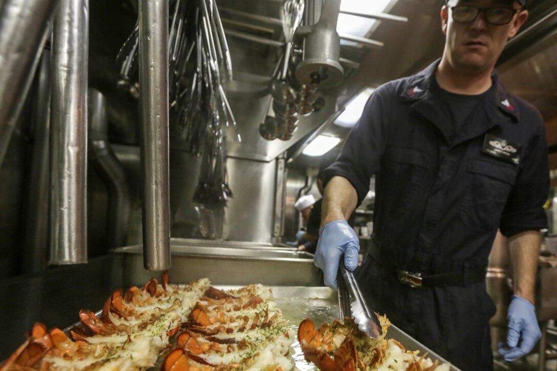 GULF OF ADEN (Oct. 29, 2015) U.S. Navy Petty Officer 1st Class Jared Webb prepares lobster tails for the October birthday dinner aboard the USS Anchorage (LPD 23). Webb is a galley supervisor aboard the Anchorage.  Marines and Sailors celebrate their birthdays for the month of October with a steak and lobster tail dinner served by their staff noncommissioned officers. The 15th Marine Expeditionary Unit, embarked on the ships of the Essex Amphibious Ready Group, is deployed to maintain regional security in the U.S. 5th Fleet area of operations. (U.S. Marine Corps photo by Sgt. Jamean Berry/Released)
