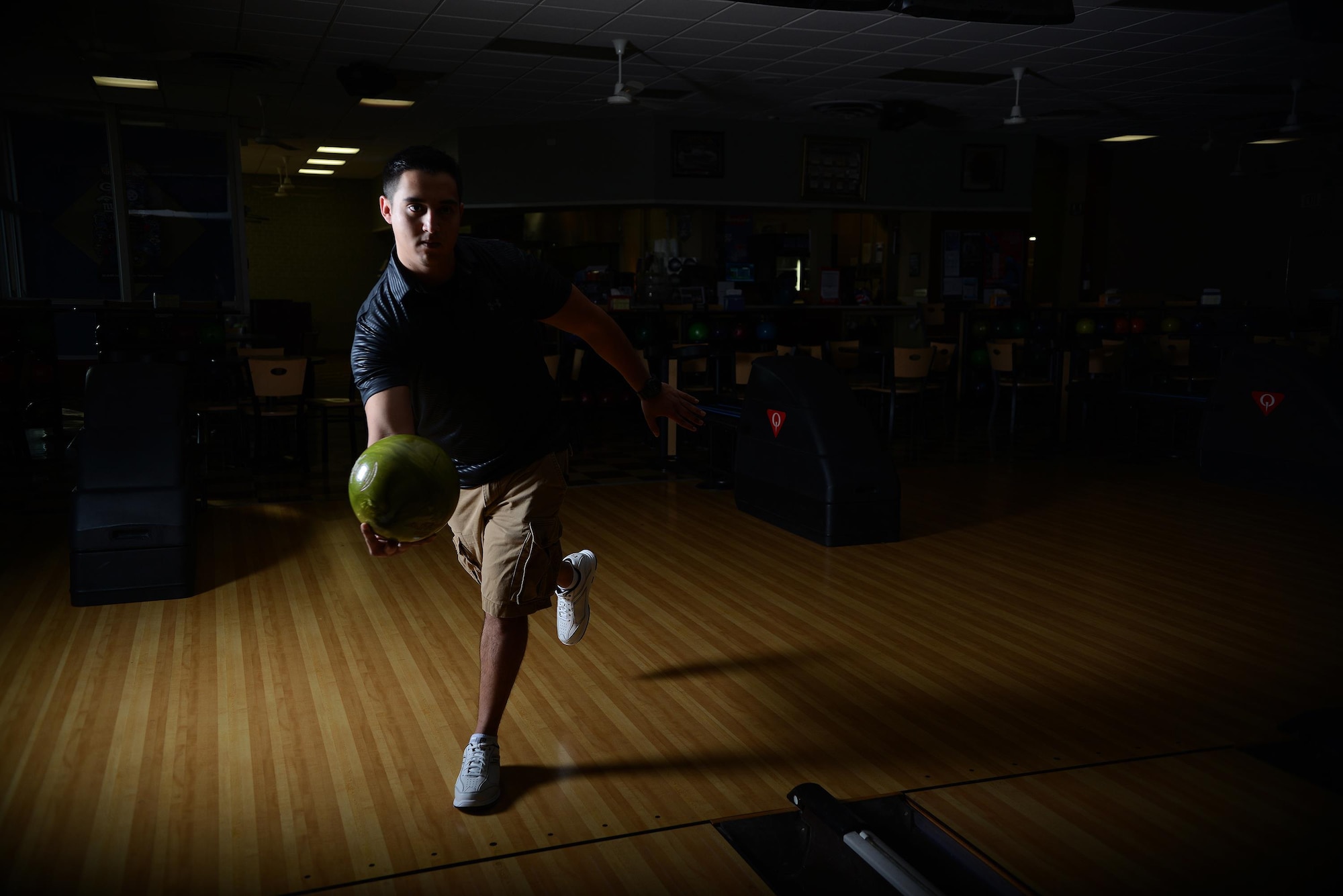 Senior Airman Javier Perez, 47th Medical Support Squadron diagnostic imaging technologist, poses at Cactus Lanes Bowling Center on Laughlin Air Force Base, Texas, Oct. 16, 2015. When not in uniform, the second place winner of the 2015 USBC Texas State tournament, singles division, is practicing his passion at the bowling center, preparing for his next bowling tournament. (U.S. Air Force photo by Airman 1st Class Ariel D. Partlow) (Released)