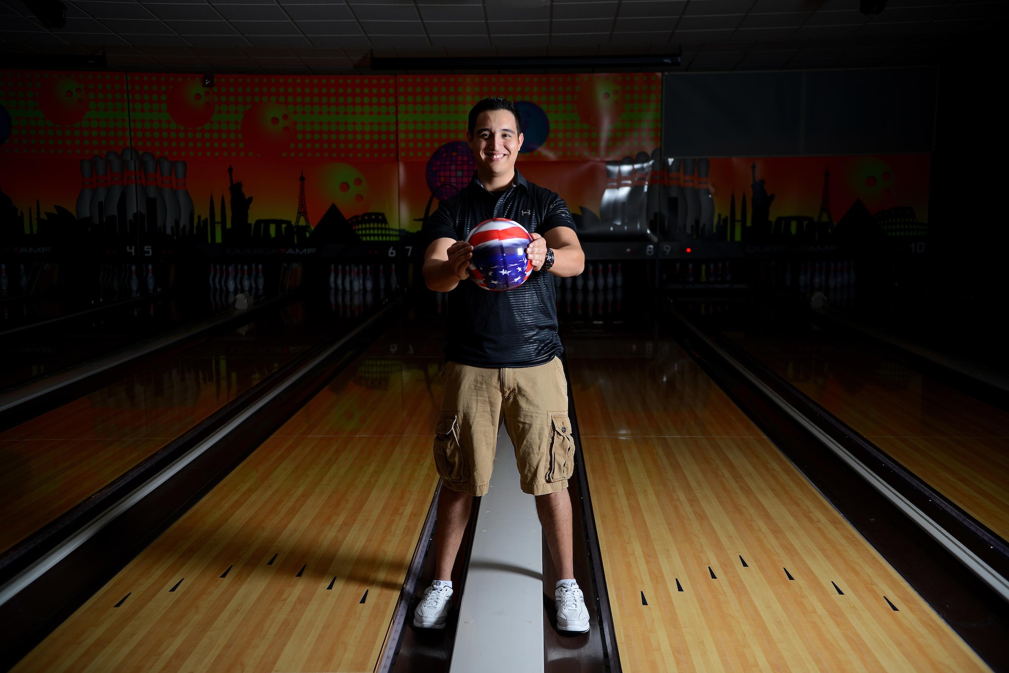 Senior Airman Javier Perez, 47th Medical Support Squadron diagnostic imaging technologist, poses at Cactus Lanes Bowling Center on Laughlin Air Force Base, Texas, Oct. 16, 2015. Perez’s hobby in bowling grew into a passion that has followed him to adulthood.  (U.S. Air Force photo by Airman 1st Class Ariel D. Partlow) (Released)