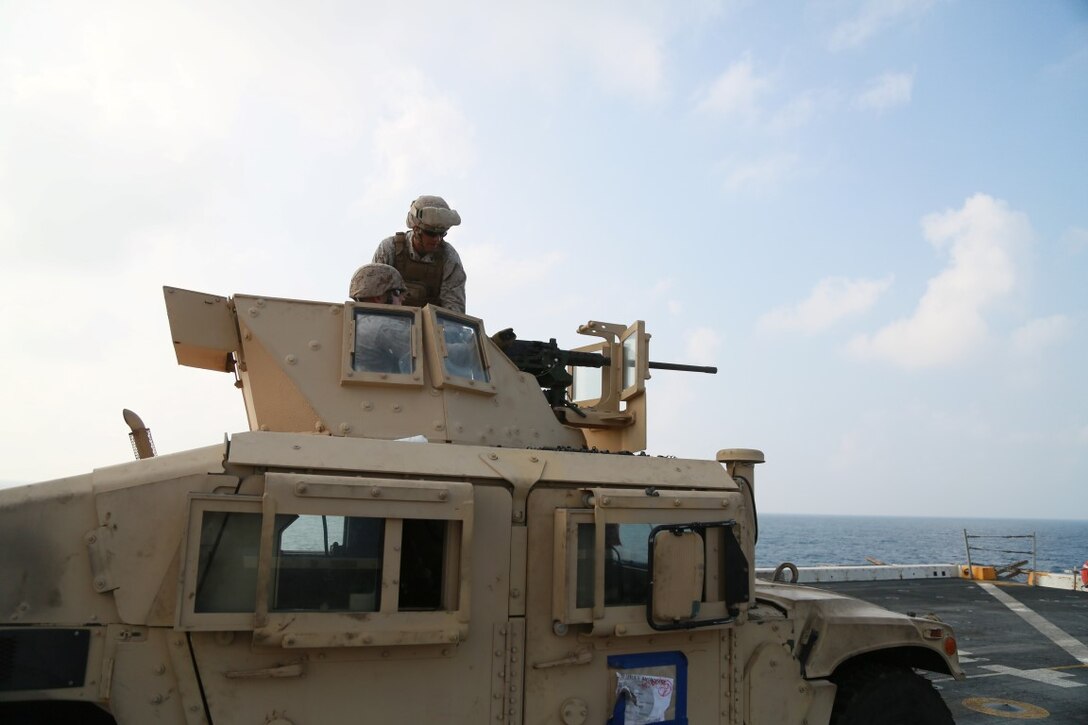 GULF OF ADEN (Oct. 29, 2015) A U.S. Marine with Combat Logistics Battalion 15, 15th Marine Expeditionary Unit, fires a .50 caliber machine gun on the flight deck of the amphibious transport dock ship USS Anchorage (LPD 23). The 15th MEU, embarked on the ships of the Essex Amphibious Ready Group, is deployed to maintain regional security in the U.S. 5th Fleet area of operations. (U.S. Marine Corps photo by Sgt. Steve H. Lopez/Released)
