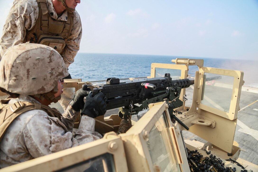 GULF OF ADEN (Oct. 29, 2015) U.S. Marine Cpl. Michelle Munoz fires a .50 caliber machine gun on the flight deck of the amphibious transport dock ship USS Anchorage (LPD 23). Munoz is a motor transport operator with Combat Logistics Battalion 15, 15th Marine Expeditionary Unit. The 15th MEU, embarked on the ships of the Essex Amphibious Ready Group, is deployed to maintain regional security in the U.S. 5th Fleet area of operations. (U.S. Marine Corps photo by Sgt. Steve H. Lopez/Released)