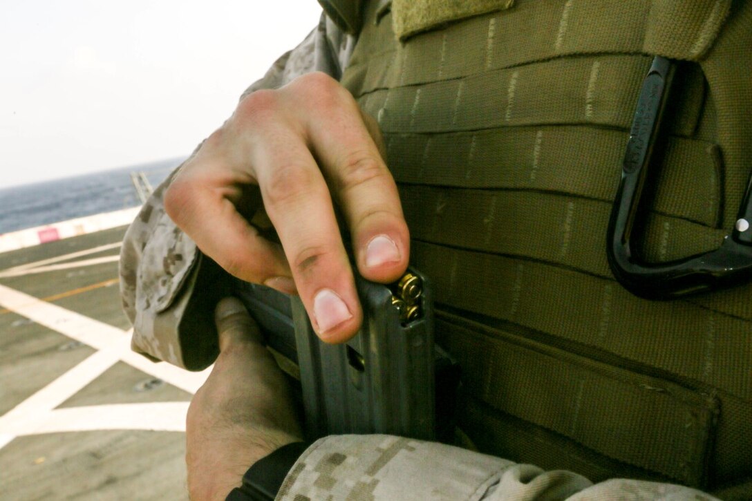 GULF OF ADEN (Oct. 31, 2015) A U.S. Marine with Combat Logistics Battalion 15, 15th Marine Expeditionary Unit, loads 5.56 mm rounds into a magazine during a deck shoot aboard the amphibious transport dock ship USS Anchorage (LPD 23). The 15th MEU, embarked on the ships of the Essex Amphibious Ready Group, is deployed to maintain regional security in the U.S. 5th Fleet area of operations. (U.S. Marine Corps photo by Sgt. Jamean Berry/Released)