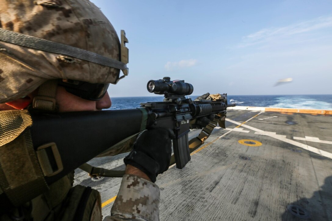 GULF OF ADEN (Oct. 31, 2015) U.S. Marine Sgt. Garrett Kastl fires an M16A4 rifle during a deck shoot aboard the amphibious transport dock ship USS Anchorage (LPD 23). Kastl is a motor transport operator with Combat Logistics Battalion 15, 15th Marine Expeditionary Unit. The 15th MEU, embarked on the ships of the Essex Amphibious Ready Group, is deployed to maintain regional security in the U.S. 5th Fleet area of operations. (U.S. Marine Corps photo by Sgt. Jamean Berry/Released)