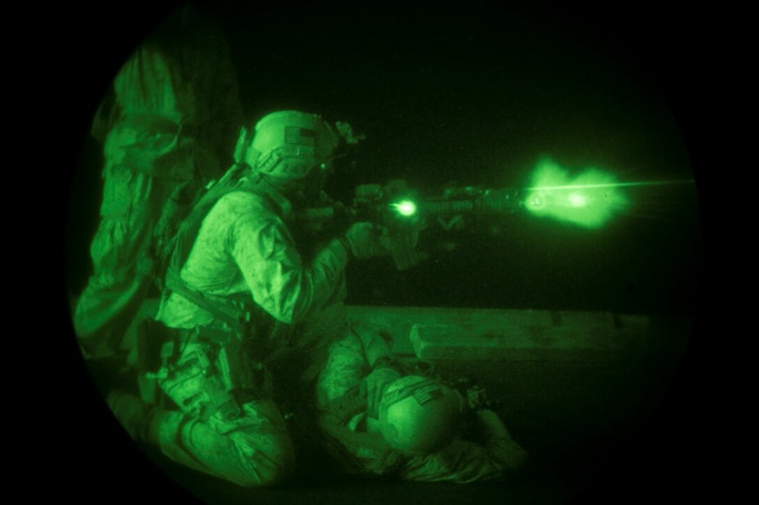 INDIAN OCEAN (Oct. 31, 2015) A U.S. Marine with the 15th Marine Expeditionary Unit’s Maritime Raid Force fires at his target during a deck shoot aboard the amphibious assault ship USS Essex (LHD 2). The Marines simulated having a down shooter, using that shooter’s ammo to suppress fire, and dragging them out of the danger zone. The 15th MEU, embarked on the ships of the Essex Amphibious Ready Group, is deployed to maintain regional security in the U.S. 5th Fleet area of operations. (U.S. Marine Corps photo by Sgt. Anna Albrecht/Released)