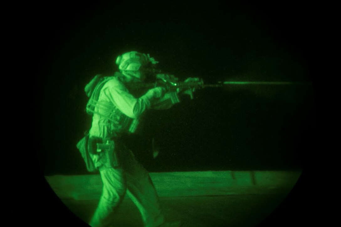 INDIAN OCEAN (Oct. 31, 2015) A U.S. Marine with the 15th Marine Expeditionary Unit’s Maritime Raid Force fires at his target during a deck shoot aboard the amphibious assault ship USS Essex (LHD 2). The Marines practiced shooting on the move at multiple targets to create more realistic drills and increase their speed and accuracy. The 15th MEU, embarked on the ships of the Essex Amphibious Ready Group, is deployed to maintain regional security in the U.S. 5th Fleet area of operations. (U.S. Marine Corps photo by Sgt. Anna Albrecht/Released)