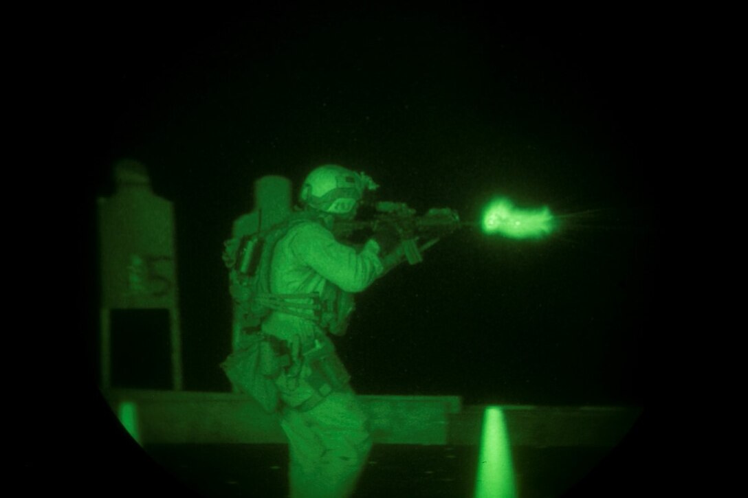 INDIAN OCEAN (Oct. 31, 2015) A U.S. Marine with the 15th Marine Expeditionary Unit’s Maritime Raid Force fires at his target during a deck shoot aboard the amphibious assault ship USS Essex (LHD 2). The Marines practiced shooting on the move at multiple targets to create more realistic drills and increase their speed and accuracy. The 15th MEU, embarked on the ships of the Essex Amphibious Ready Group, is deployed to maintain regional security in the U.S. 5th Fleet area of operations. (U.S. Marine Corps photo by Sgt. Anna Albrecht/Released)