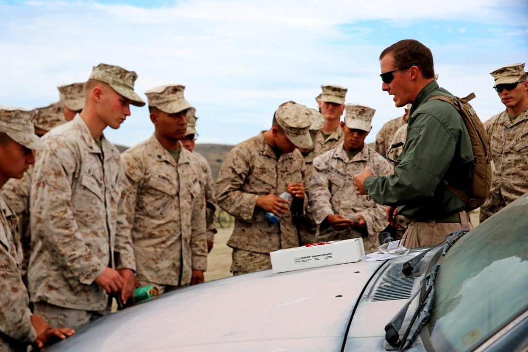An instructor with the Marine Corps Engineer Society teaches Marines with Headquarters and Service Company, 1st Battalion, 5th Marine Regiment, 1st Marine Division, how to inspect for hazardous chemicals during searchers and site exploitation training aboard Marine Corps Base Camp Pendleton, Calif., Oct. 27-29, 2015. The three-day training period provided 1/5 personnel with instruction on how to identify threats within a designated area and conduct systematic searches using appropriate detection equipment.   (U.S. Marine Corps photo by Cpl. Demetrius Morgan/RELEASED)