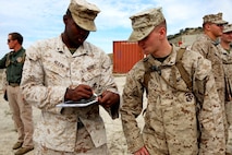 Marines with Headquarters and Service Company, 1st Battalion, 5th Marine Regiment, 1st Marine Division, discuss possible threats within the area during searchers and site exploitation training aboard Marine Corps Base Camp Pendleton, Calif., Oct. 27-29, 2015. The three-day training period provided 1/5 personnel with instruction on how to identify threats within a designated area and conduct systematic searches using appropriate detection equipment. (U.S. Marine Corps photo by Cpl. Demetrius Morgan/RELEASED)