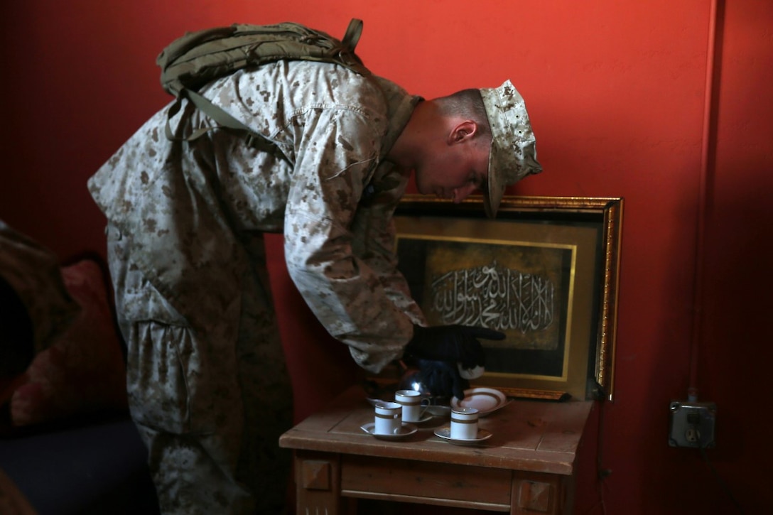 Marines with Headquarters and Service Company, 1st Battalion, 5th Marine Regiment, 1st Marine Division, speak with a role-playing suspect while searching his house during searchers and site exploitation training aboard Marine Corps Base Camp Pendleton, Calif., Oct. 29, 2015. Instructors with the Marines Corps Engineer Society taught the Marines the skills they need to locate and collect evidence on munitions or against suspected individuals in a realistic training environment.