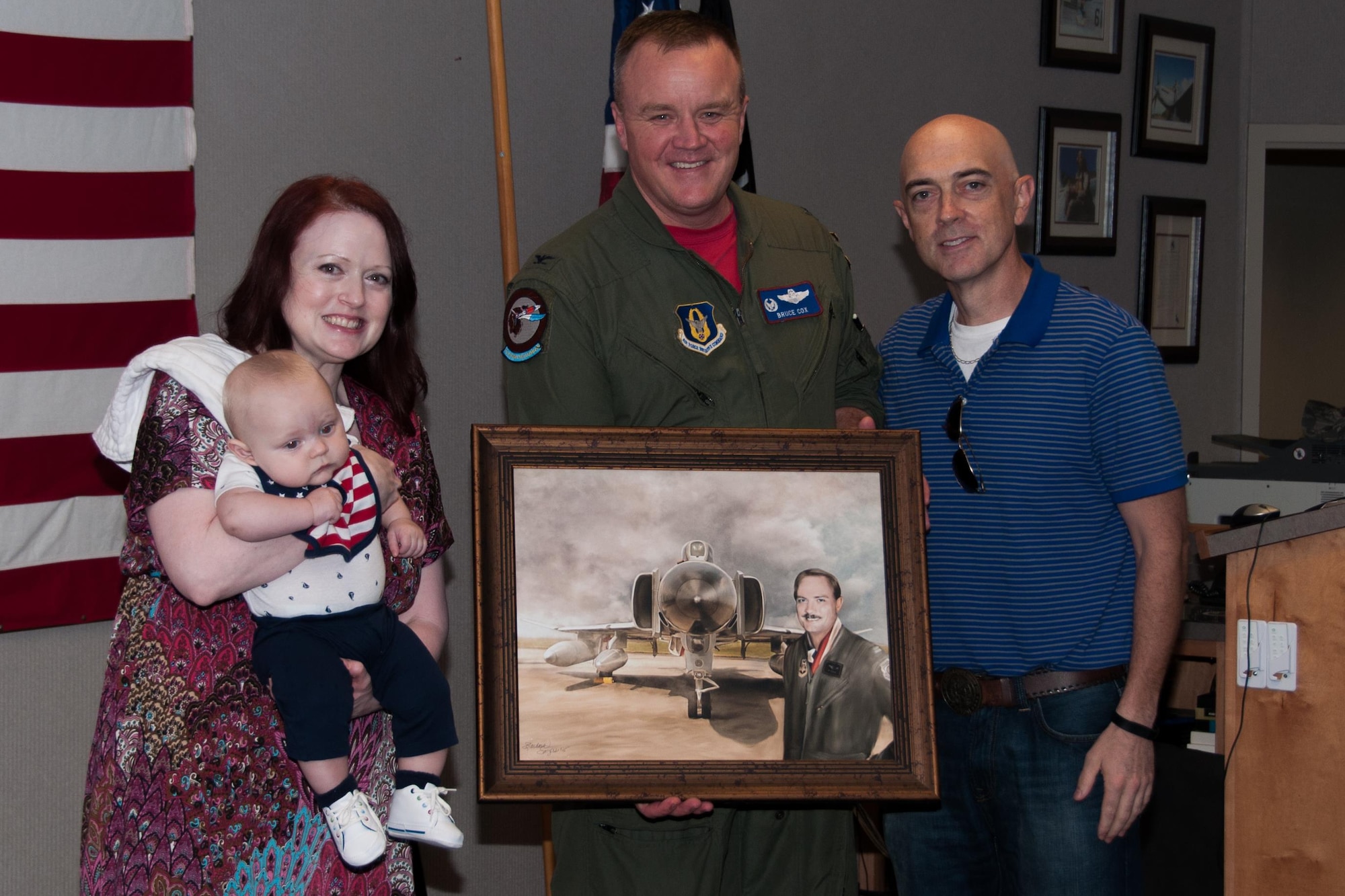 U.S. Air Force Col. Bruce Cox, commander of the 307th Bomb Wing at Barksdale Air Force Base in La., presents Christina Tindel and Adam Pitchford with a picture in memoriam to their father, Maj. Robert W. Pitchford on behalf of the 457th Fighter Squadron “Spads,” on Oct. 23, 2015 at Naval Air Station, Joint Reserve Base Fort Worth, Texas. Maj. Pitchford was assigned to the 457th Fighter Squadron when he died in an aircraft crash near Carswell AFB, Texas.  The “Spads” have a memorial of Robert W. Pitchford in their building. (U.S. Air Force photo by Master Sgt. Laura Siebert/Released)