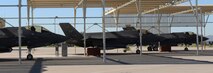 Three F-35s from the 61st Fighter Squadron sit under the shade of the flightline, Nov. 2, 2015, at Luke Air Force Base. The 61st Fighter Squadron trains pilot instructors to be mission-ready operational F-35 pilots who will train other F-35 pilots in the future. (U.S. Air Force photo by Airman 1st Class Ridge Shan)