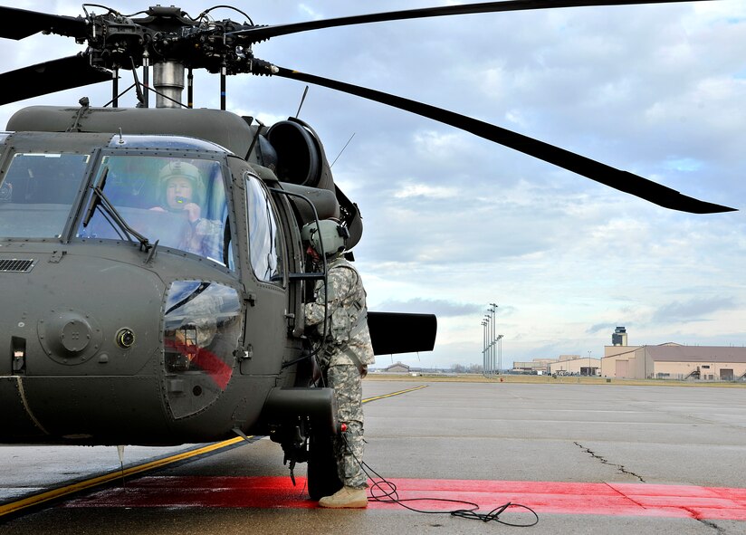 A Bismarck, North Dakota Army National Guard 285th Aviation Regiment, 2nd Battalion, Charlie Company, member prepares students from the University of North Dakota Army Reserve Officer Training Course (ROTC) for an orientation flight in a UH-60 Black hawk Oct. 31, 2015, on Grand Forks Air Force Base, North Dakota. The orientation flight is part of their ROTC curriculum which includes classroom activities, leadership labs and physical training. (U.S. Air Force photo by Senior Airman Xavier Navarro/Released)