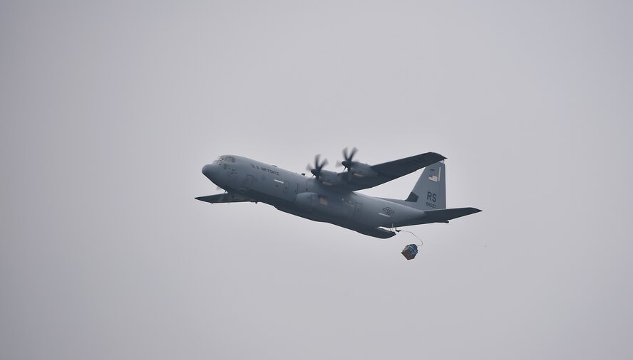 A U.S. Air Force C-130J Super Hercules drops a bundle as part of a friendly airlift competition during Aviation Detachment 16-1, Oct. 29, 2015, at Powdiz Air Base, Poland. The competition was a two-part event, involving airdrops and landings. The 37th Airlift Squadron claimed first place in air drops, while the Polish air force took first in landings. (U.S. Air Force photo/Senior Airman Damon Kasberg)
