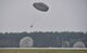 A bundle falls toward the point of impact as part of a friendly airlift competition between the Polish and U.S. air forces during Aviation Detachment 16-1, Oct. 29, 2015, at Powidz Air Base, Poland. The aircrew able to get their bundle to drop the closest to the point of impact was declared the winner. The 37th Airlift Squadron claimed first place in air drops. (U.S. Air Force photo/Senior Airman Damon Kasberg)