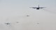 U.S. and Polish C-130s fly in formation prior to participating in a friendly airlift competition during Aviation Detachment 16-1, Oct. 29, 2015, at Powidz Air Base, Poland. A total of seven aircraft few together, marking the largest C-130 formation at Powdiz. (U.S. Air Force photo/Senior Airman Damon Kasberg)