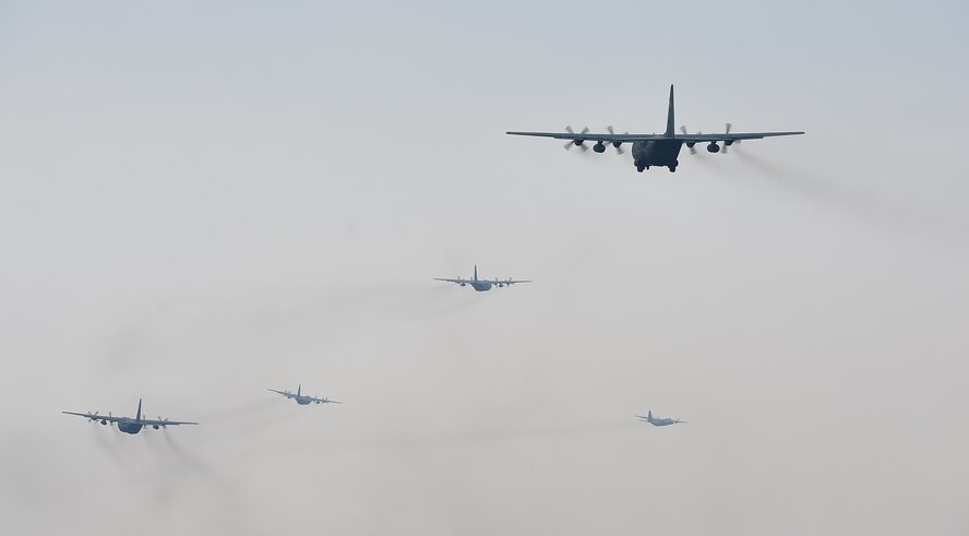 U.S. and Polish C-130s fly in formation prior to participating in a friendly airlift competition during Aviation Detachment 16-1, Oct. 29, 2015, at Powidz Air Base, Poland. A total of seven aircraft few together, marking the largest C-130 formation at Powdiz. (U.S. Air Force photo/Senior Airman Damon Kasberg)
