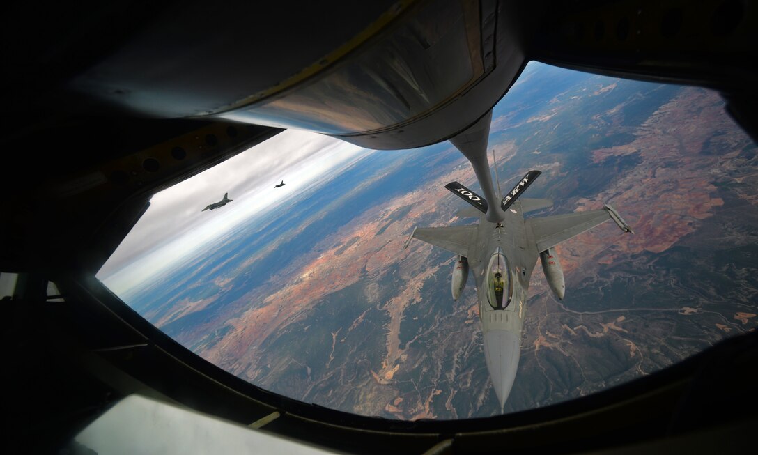 A Portuguese air force F-16 takes fuel from a KC-135 Stratotanker from the 100th Air Refueling Wing, Oct. 23, 2015, over southern Spain. Both aircraft are participating in Exercise Trident Juncture 2015, which consists of combined training and security cooperation efforts enabling allies and partners to respond more effectively to regional crises, improve the security of borders, ensure energy security, and counter threats. (U.S. Air Force photo by Senior Airman Christine Halan/Released)