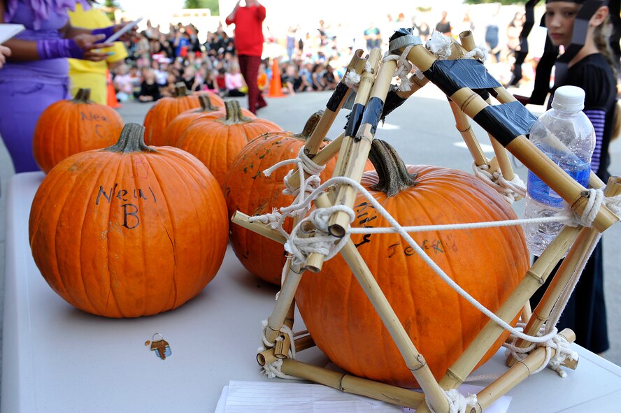 Pumpkins wait for their wounds to be inspected by Stearley Heights Elementary School teachers after being dropped from the top of the school building Oct. 30, 2015, at Kadena Air Base, Japan. A total of seven teams from the 5th grade class were tasked to generate a container that would protect their pumpkin from breaking after being dropped from the top of the building. (U.S. Air Force photo by Naoto Anazawa)