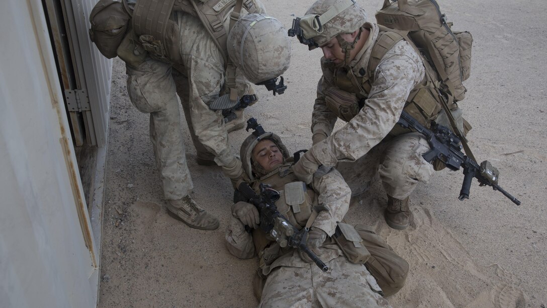 Lance Corporal John Roan, center, a squad leader with E Company, 2nd Battalion, 2nd Marine Regiment gets carried away from the simulated improvised explosive device blast by another Marine and Navy Corpsman while conducting counter-IED training during Integrated Training Exercise 1-16 at Marine Air Ground Combat Center, Twentynine Palms, Calif., Oct. 29, 2015. Marines at ITX demonstrate core infantry mission essential tasks while conducting offensive and defensive operations. 