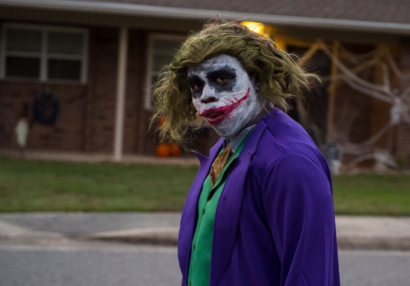 U.S. Air Force Staff Sgt. Travis Dinkins, 23d Operations Support Squadron air traffic controller, roams the streets with his family at Quiet Pines base housing while children trick or treat, Oct. 31, 2015, at Moody Air Force Base, Ga. Hundreds of families participated in Moody’s Trunk or Treat at the youth center and trick or treating at Quiet Pines base housing. (U.S. Air Force photo by Senior Airman Ceaira Tinsley/Released)