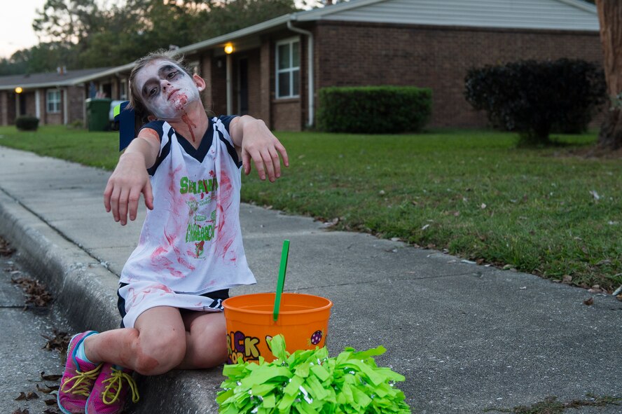 Annabella, daughter of U.S. Air Force Staff Sgt. Robert Marfilius, 723d Aircraft Maintenance Squadron, portrays her zombie costume, Oct. 31, 2015, at Moody Air Force Base, Ga. Moody held Trunk or Treat at the youth center and trick or treating at Quiet Pines base housing. (U.S. Air Force photo by Senior Airman Ceaira Tinsley/Released)