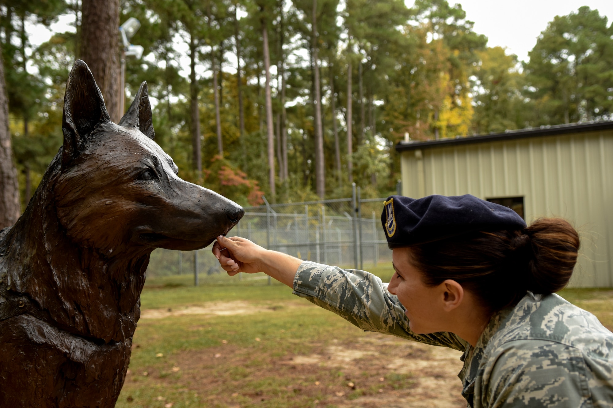 Staff Sgt. Kristina Dennison, 4th Security Forces Squadron military working dog handler, checks out the detail on the War Dog Memorial statue, Oct. 27, 2015, at Seymour Johnson Air Force Base, North Carolina. The statue is dedicated to all dogs, past and present, who served in the military. (U.S. Air Force photo/Airman Shawna L. Keyes)