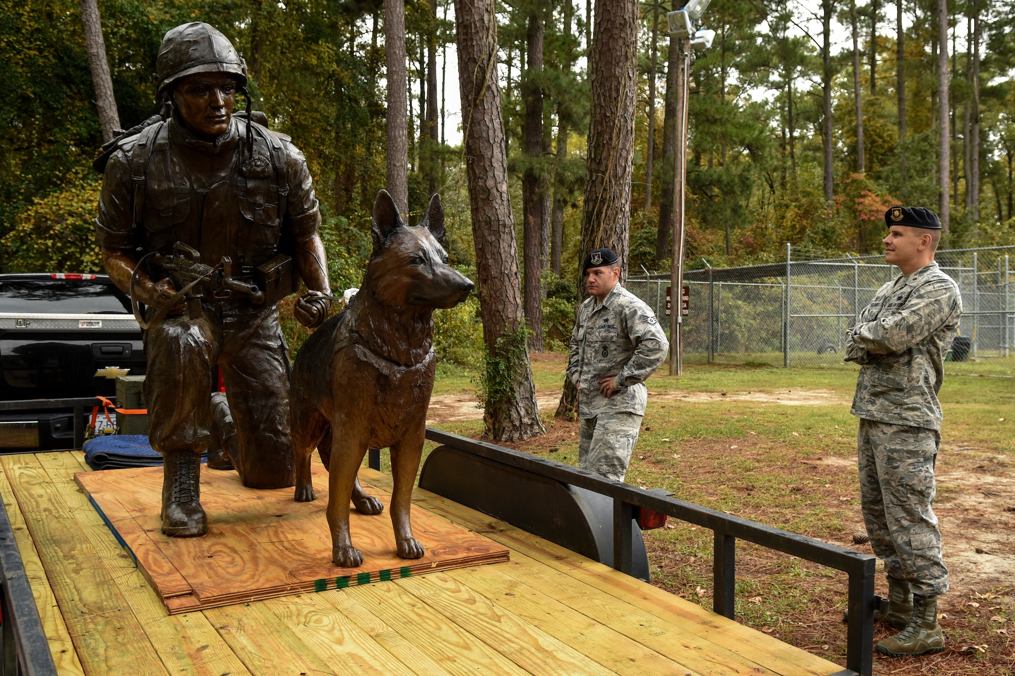 Staff Sgt. John Makripodis (left), 4th Security Forces Squadron kennel master, and Maj. Brent Gallant, 4th SFS commander, admire a War Dog Memorial statue, Oct. 27, 2015, at Seymour Johnson Air Force Base, North Carolina. Before reaching its permanent home at Veterans Memorial Park in Columbia, South Carolina, the statue traveled around North Carolina to all military installations for viewing. (U.S. Air Force photo/Airman Shawna L. Keyes)