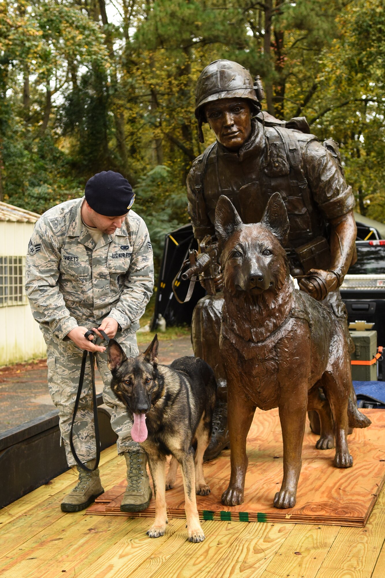 Senior Airman Brandon Sheets, 4th Security Forces Squadron military working dog handler, and MWD Miko check out the War Dog Memorial statue, Oct. 27, 2015, at Seymour Johnson Air Force Base, North Carolina. The statue was made in the likeness of Johnny Mayo, a scout dog handler who served with the Army’s 39th Scout Dog platoon during the Vietnam War, and his scout dog Tiger. (U.S. Air Force photo/Airman Shawna L. Keyes) 
