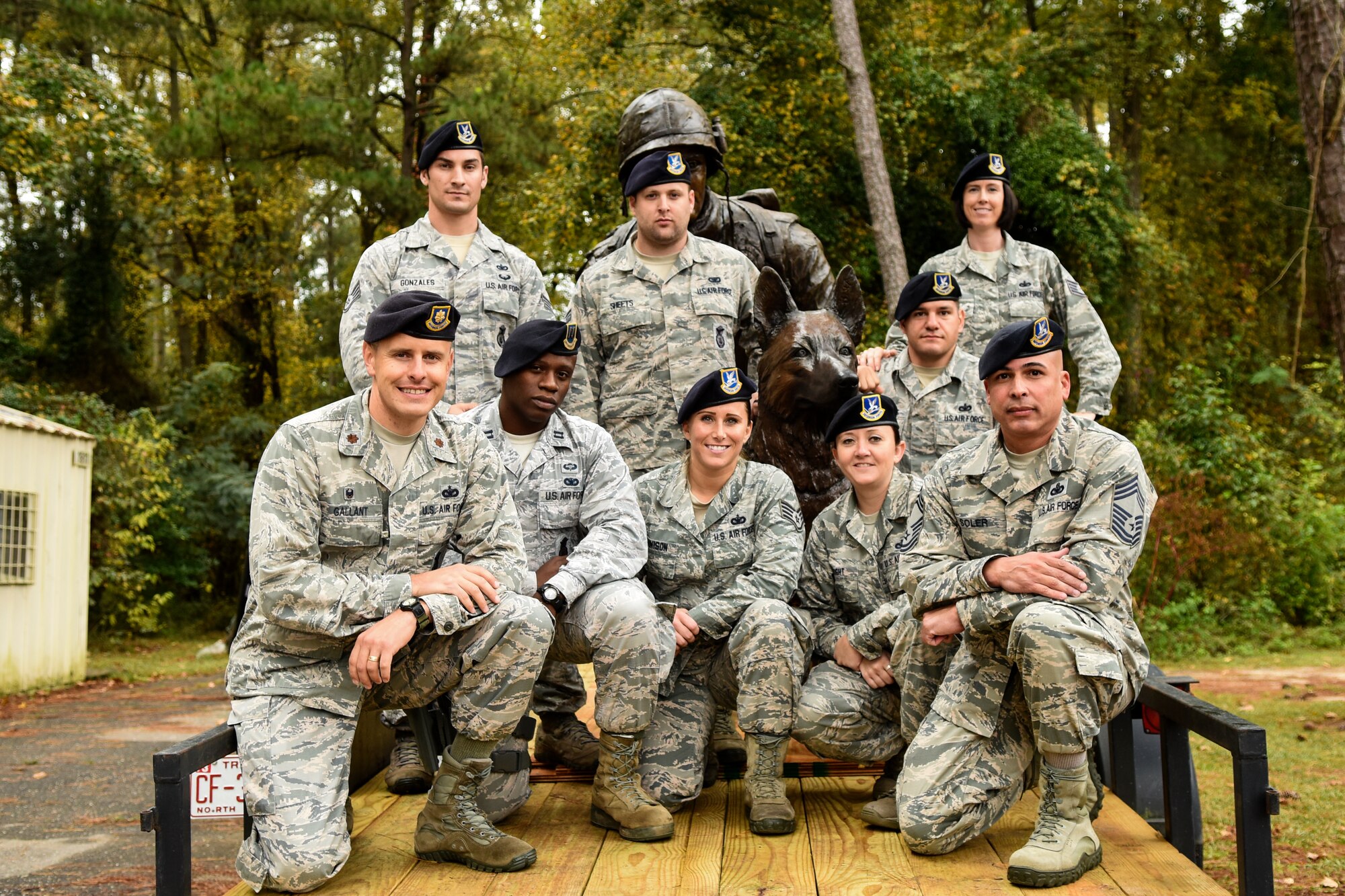 Airmen from the 4th Security Forces Squadron pose with the War Dog Memorial statue, Oct. 27, 2015, at Seymour Johnson Air Force Base, North Carolina. The statue traveled around North Carolina to different military installations before heading to its permanent home at the Veterans Memorial Park in Columbia, South Carolina. (U.S. Air Force photo/Airman Shawna L. Keyes)   