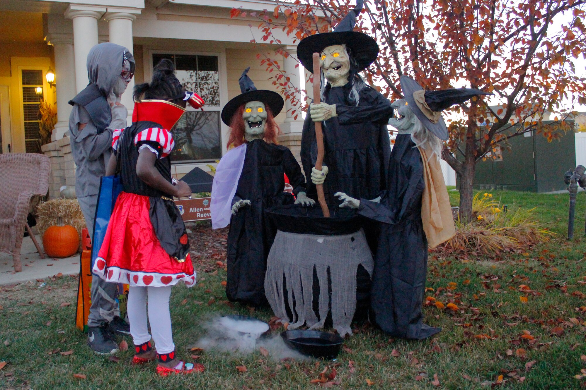 Team Buckley youth admire Halloween decorations in base housing Oct. 31, 2015, on Buckley Air Force Base, Colo. Children in base housing walked the neighborhood in costumes and received candy and treats from neighbors. (U.S. Air Force photo by Staff Sgt. Darren Scott/Released)