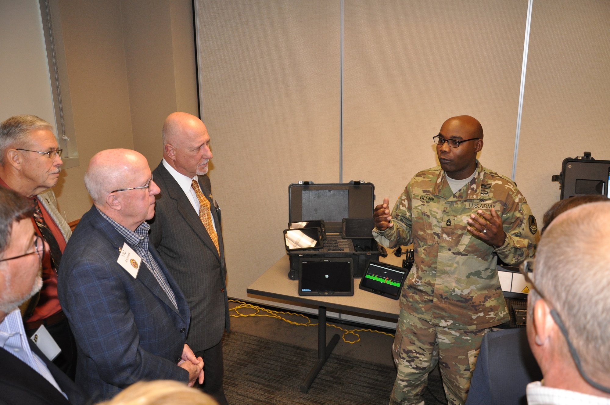 PETERSON AIR FORCE BASE, Colo. - Sgt. 1st Class Paul Glenn, operations sergeant, U.S. Army Space and Missile Defense Command/Army Forces Strategic Command, explains some of the uses of space kits to the Colorado Thirty Group during a visit to the command's Colorado Springs headquarters Oct. 27. (Photo by Dottie White)