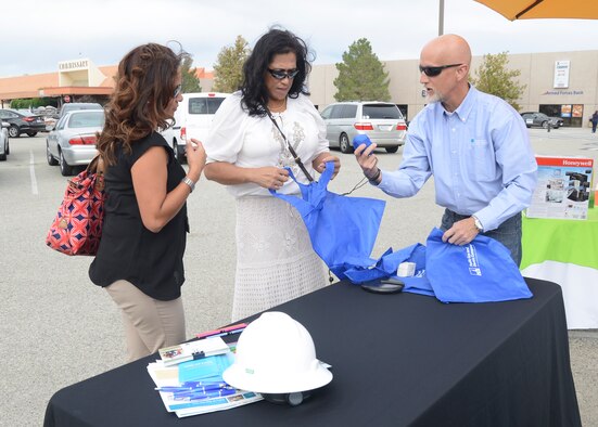 A representative (right) from Pacific Gas and Electric passes out promotional items Oct. 28 at the finale of Edwards AFB's Energy Action Month campaign. PG&E was joined by Southern California Edison, the 412th Civil Engineering Group and the Exchange during the event.(U.S. Air Force photo by Kenji Thuloweit)