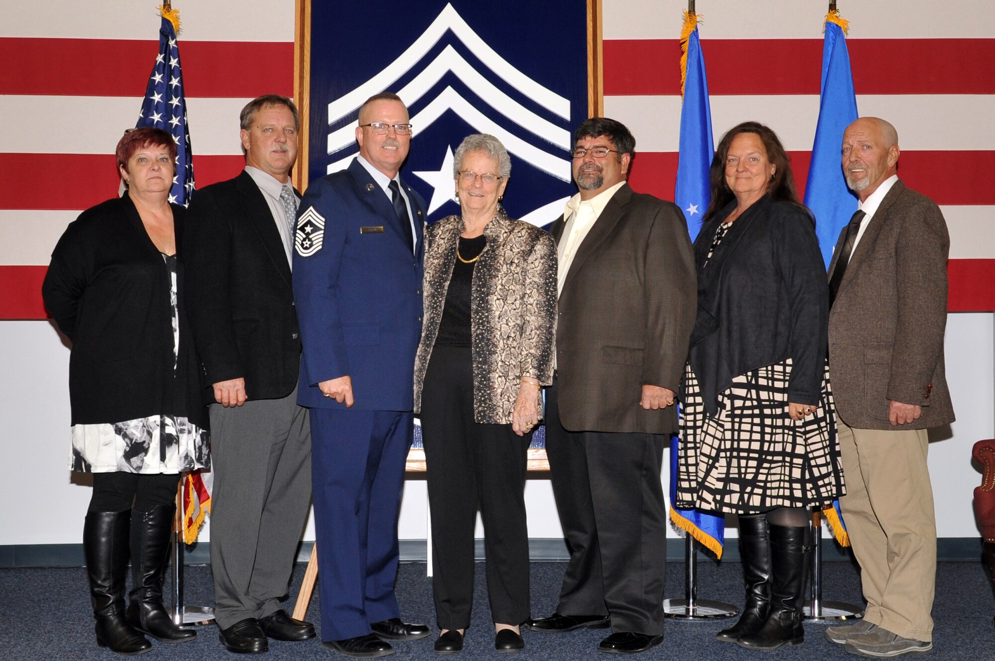 Chief Master Sgt. David Duncan, former 319th Air Base Wing command chief master sergeant, is pictured with his family Oct. 30, 2015, at his retirement ceremony at the base honor guard building on Grand Forks Air Force Base, North Dakota. Duncan is retiring after 30 years of service. (U.S. Air Force photo/Staff Sgt. Susan L. Davis)