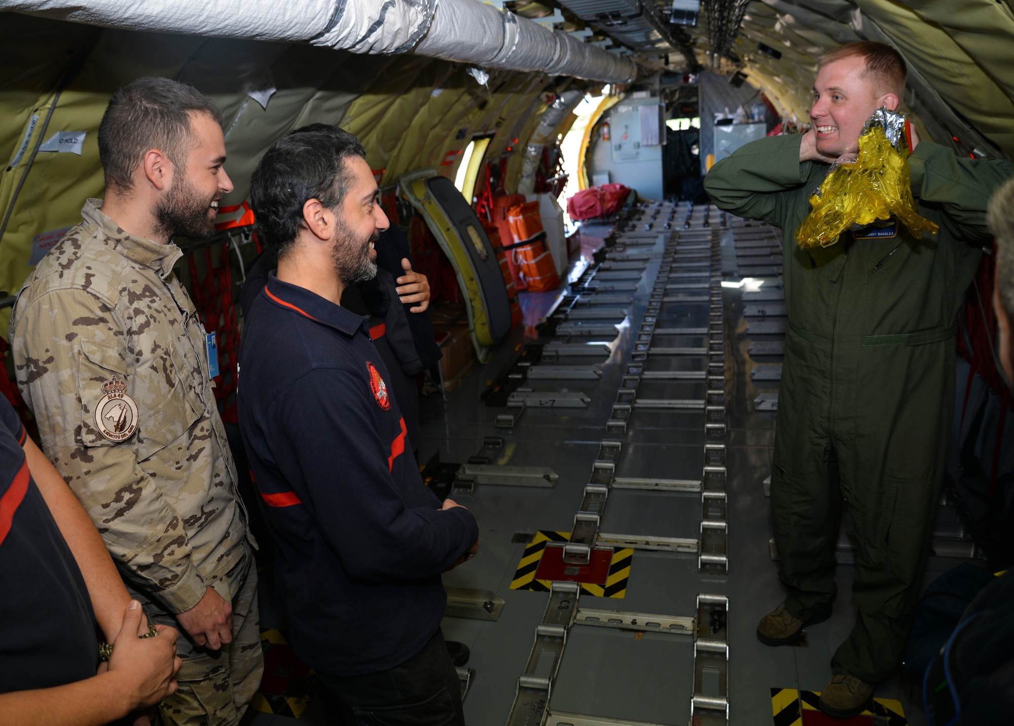 U.S. Air Force Master Sgt. Larry Nahalea, 351st Air Refueling Squadron boom operator, explains how to use an emergency passenger oxygen system to Spanish military firefighters, Oct. 23, 2015 at Son San Juan Air Base, Spain. The Spanish military members were given the opportunity to fly in the 100th Air Refueling Wing KC-135 Stratotanker to witness air refueling for Exercise Trident Juncture 2015. (U.S. Air Force photo by Senior Airman Christine Halan/Released)