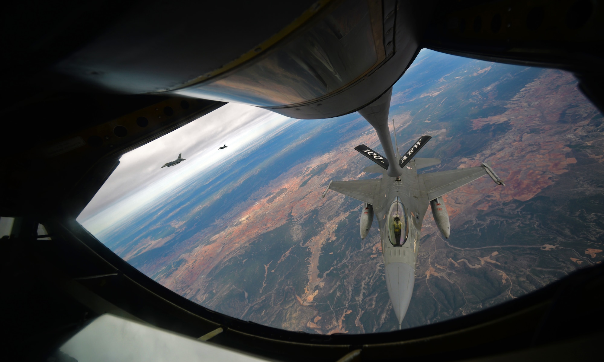 A Portuguese air force F-16 takes fuel from a KC-135 Stratotanker from the 100th Air Refueling Wing, Oct. 23, 2015, over southern Spain. Both aircraft are participating in Exercise Trident Juncture 2015, which consists of combined training and security cooperation efforts enabling allies and partners to respond more effectively to regional crises, improve the security of borders, ensure energy security, and counter threats. (U.S. Air Force photo by Senior Airman Christine Halan/Released)