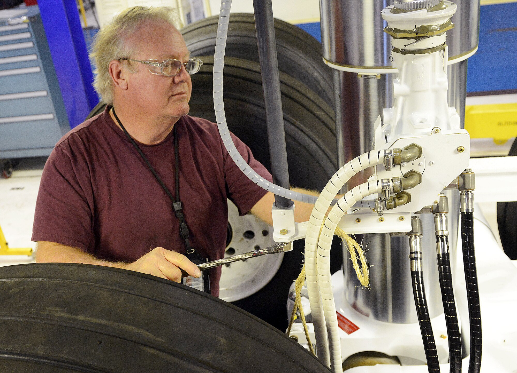 Rodger Sexton, 569th Aircraft Maintenance Squadron hydraulics mechanic, performs final inspection of a C-5 landing gear built up at Robins. The enormous C-5 Galaxy has a very unique landing gear system consisting of a single nose strut, four main bogeys and a total of 28 wheels. (U.S. Air Force photo by Tommie Horton)