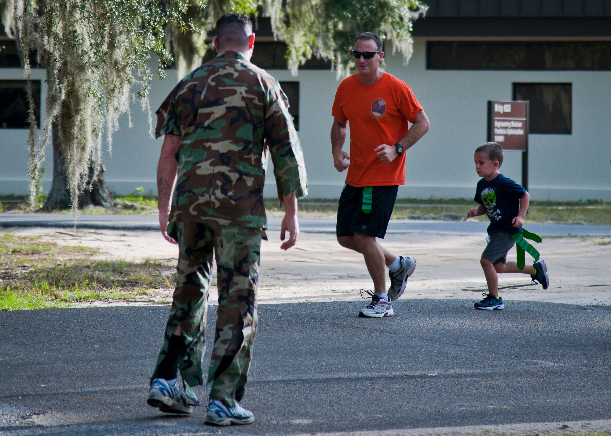 A father-son team prepares to escape an Air Force zombie during the annual Zombie Stomp run Oct. 30 at Eglin Air Force Base, Fla.  More than 150 turned out to duck, dodge and outrun zombie hordes throughout the 5k run.  (U.S. Air Force photo/Samuel King Jr.)