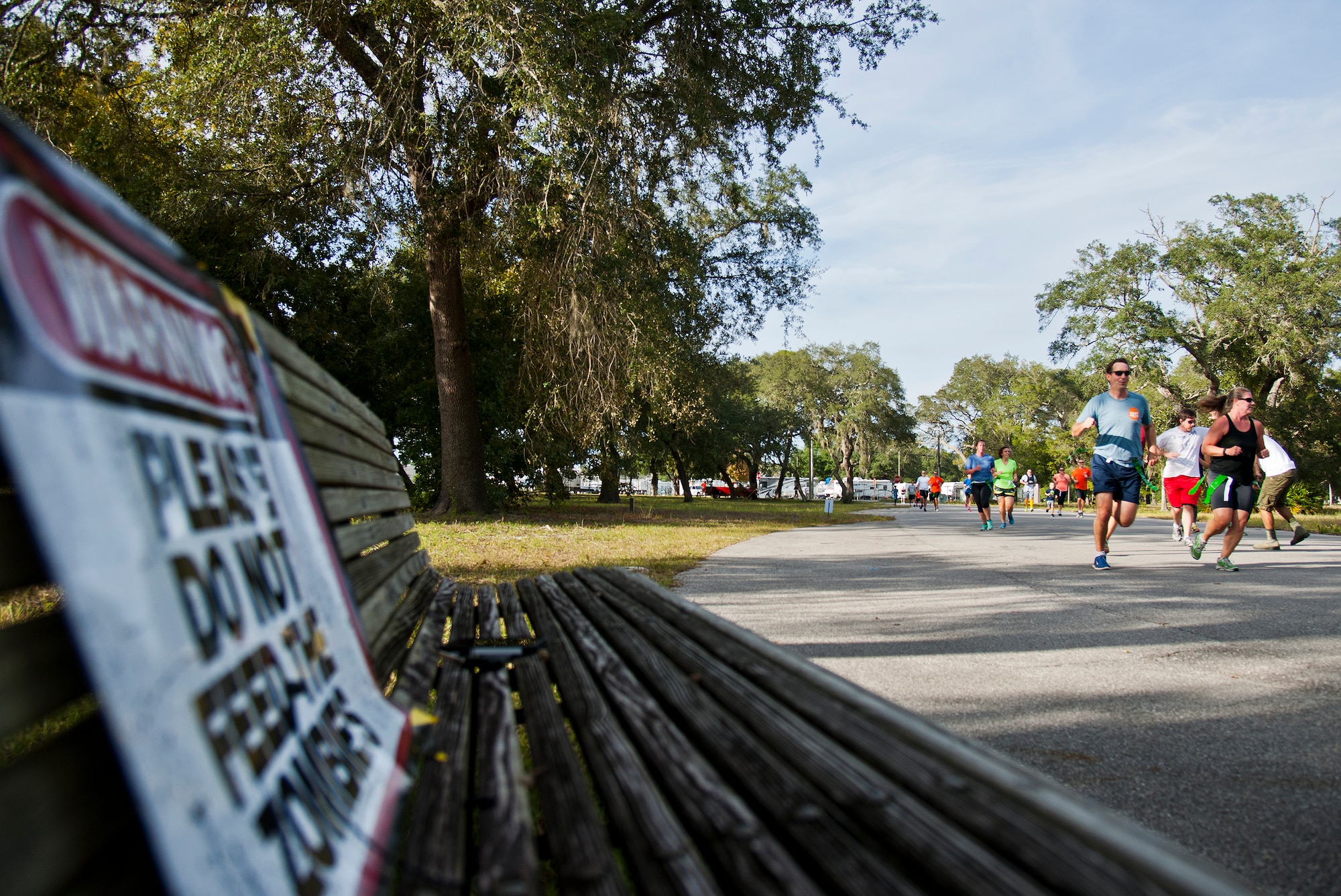 Participants try to heed the advice of the signs around the base during the annual Zombie Stomp run Oct. 30 at Eglin Air Force Base, Fla.  More than 150 turned out to duck, dodge and outrun zombie hordes throughout the 5k run.  (U.S. Air Force photo/Samuel King Jr.)