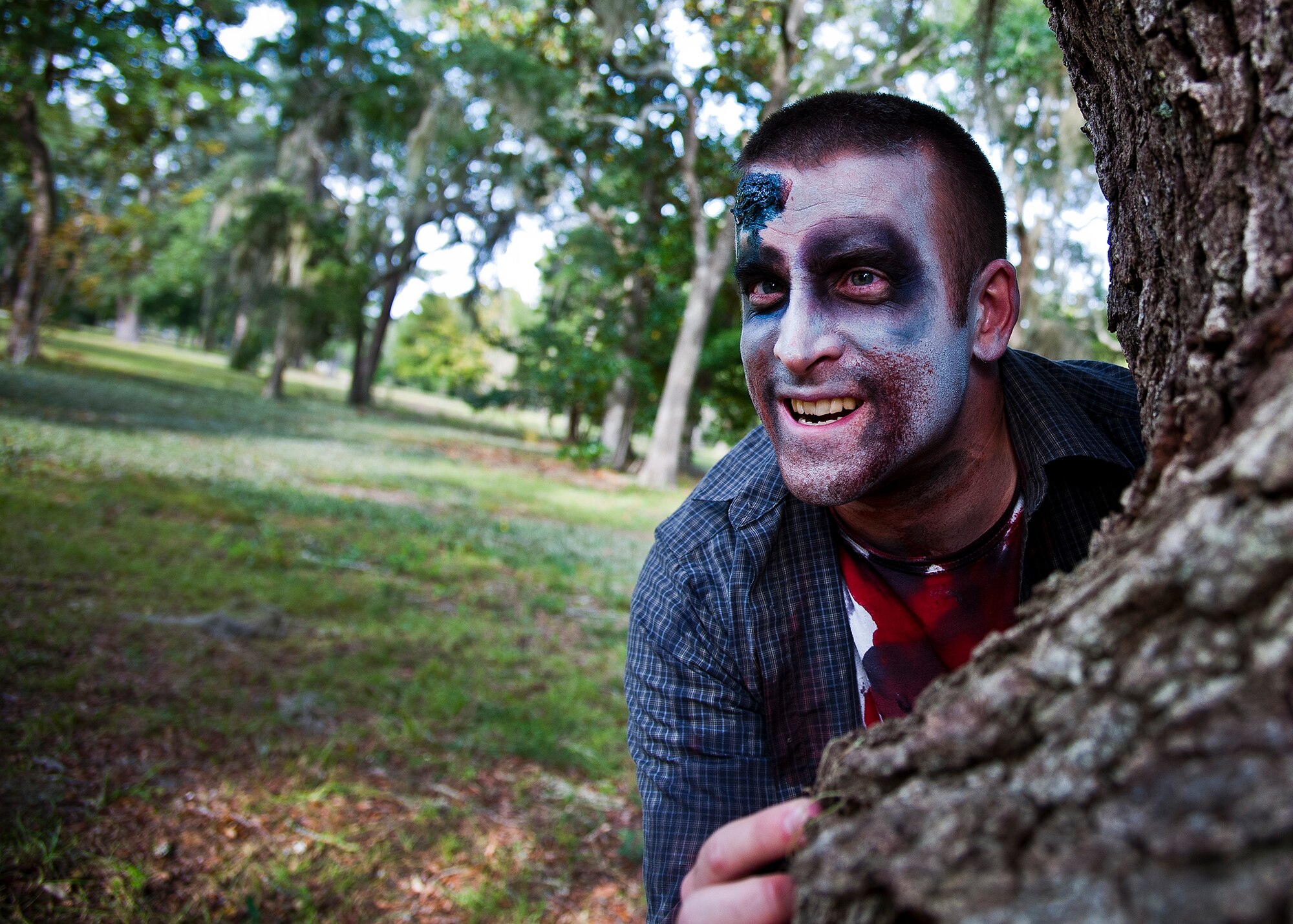 A zombie peeks around a tree searching for his “dinner” during the annual Zombie Stomp run Oct. 30 at Eglin Air Force Base, Fla.  More than 150 turned out to duck, dodge and outrun zombie hordes throughout the 5k run.  (U.S. Air Force photo/Samuel King Jr.)