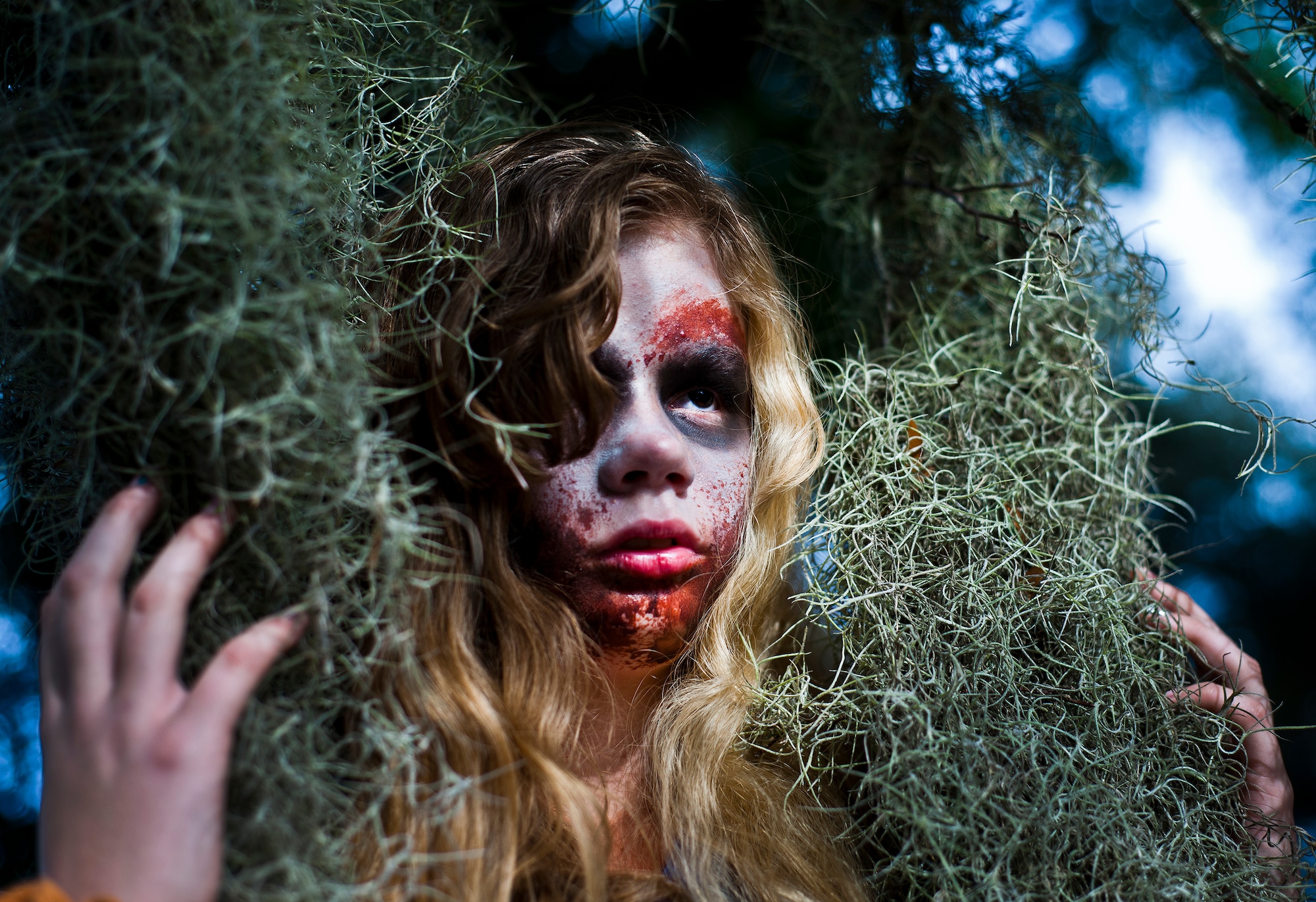 A zombie hides out underneath the trees waiting for her next meal during the annual Zombie Stomp run Oct. 30 at Eglin Air Force Base, Fla.  More than 150 turned out to duck, dodge and outrun zombie hordes throughout the 5k run.  (U.S. Air Force photo/Samuel King Jr.)