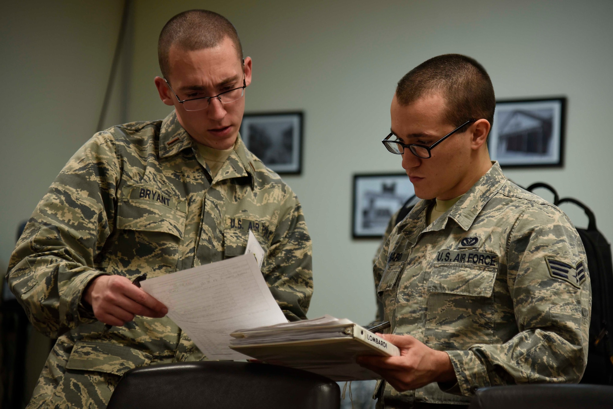 U.S. Air Force Senior Airman Vincent Lombardi, 35th Civil Engineer Squadron electrical systems journeyman, has his personnel file reviewed during Phase I of exercise Beverly Sunrise 16-01 at Misawa Air Base, Japan, Nov. 1, 2015. Lombardi, along with other Airmen, went through the personnel deployment function line where records containing immunizations, existing medical conditions and even their will are reviewed before deploying to their next destination. (U.S. Air Force photo by Airman 1st Class Jordyn Fetter/Released)