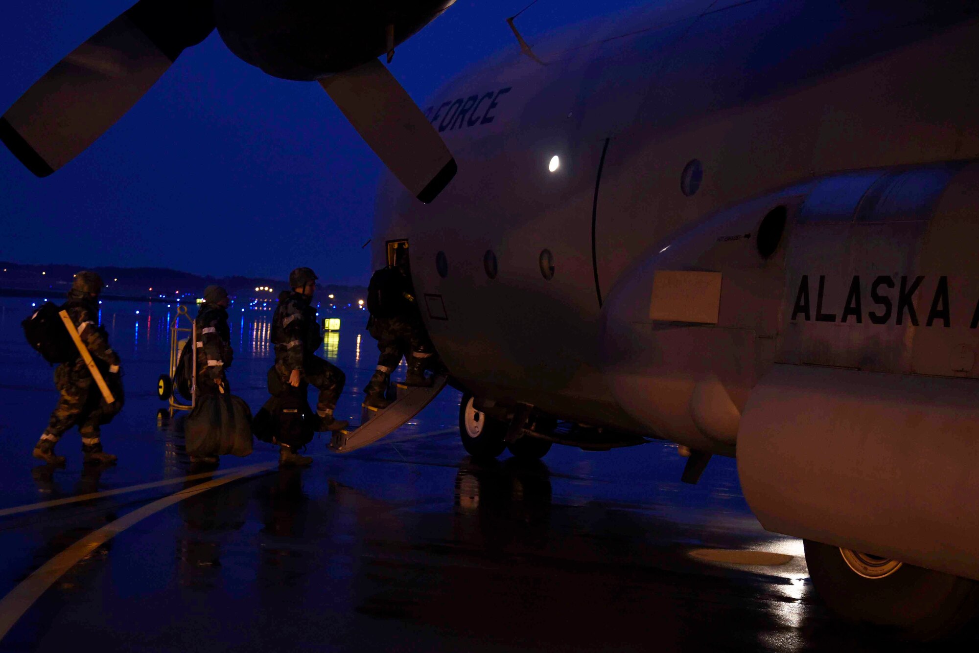Airmen with the 35th Fighter Wing walk to an awaiting C-130 Hercules aircraft during exercise Beverly Sunrise 16-01 at Misawa Air Base, Japan, Nov. 1, 2015. The C-130 was heading to Osan Air Base, Korea in support of power projection within the Indo-Asian-Pacific region. The ?Beverly Sunrise? series of exercises are designed to test the readiness of Airmen within Pacific Air Forces? region of responsibility. (U.S. Air Force photo by Airman 1st Class Jordyn Fetter/Released)
