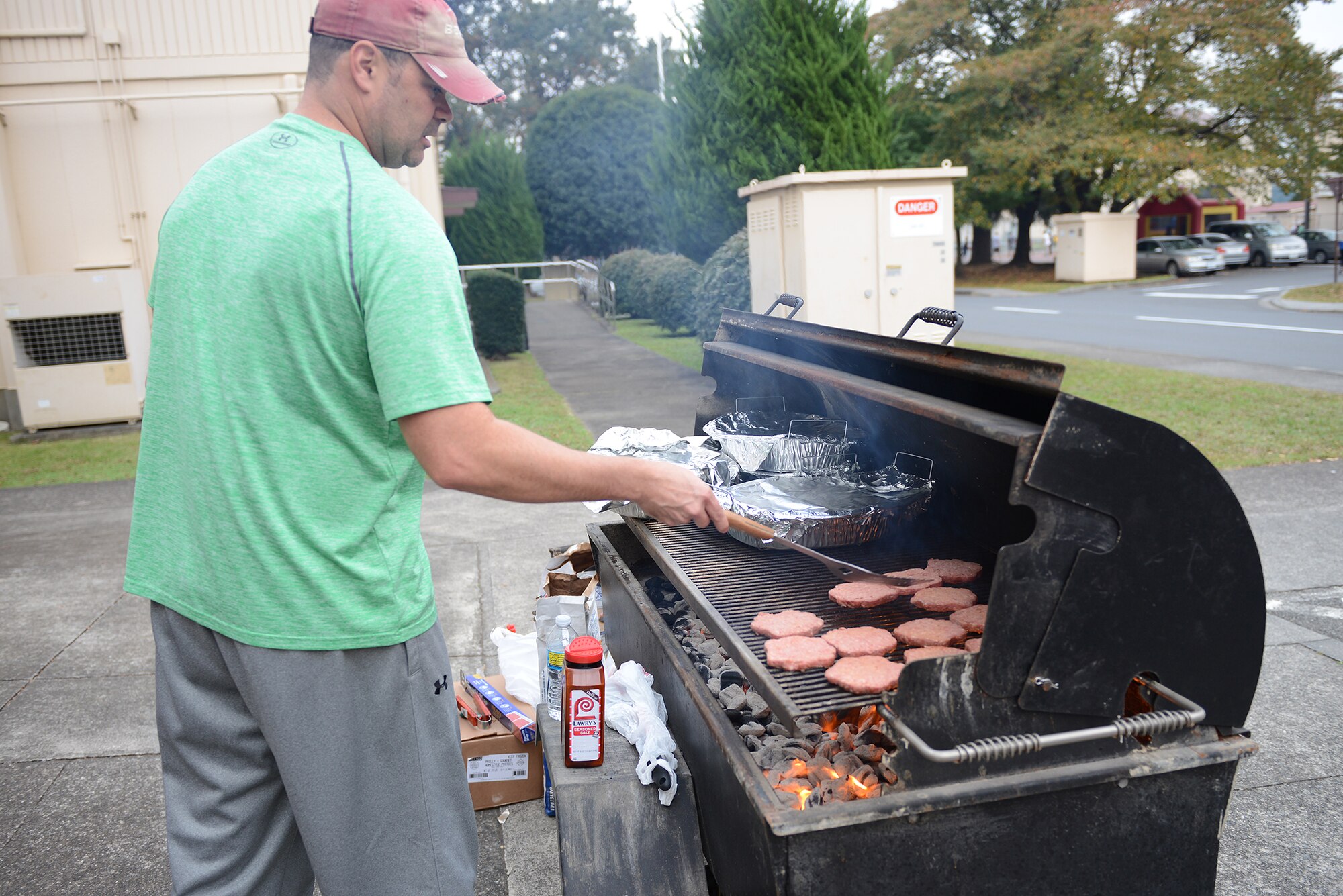 Master Sgt. Ryan Smith, 374th Maintenance Squadron aerospace ground equipment flight assistant flight chief, grills hamburgers for orphans visiting Yokota Air Base, Japan, Oct. 31, 2015. During the Halloween visit, the children swam at the natatorium, played on bouncy castles and went through the child friendly version of the 'Yokota Insane Asylum' haunted house.  (U.S. Air Force photo by Senior Airman David C. Danford/Released)