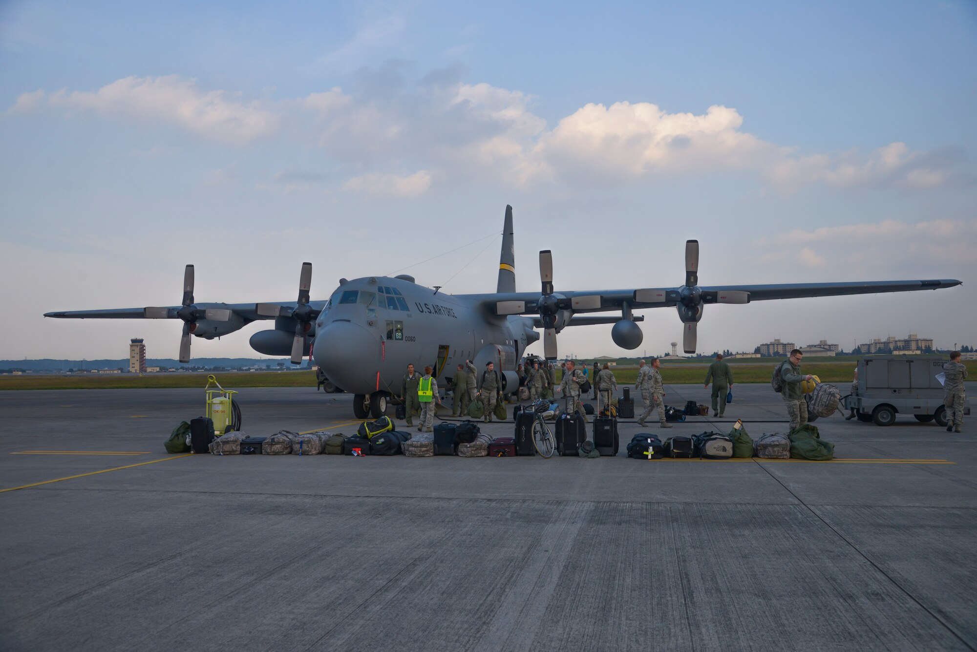 Airmen from the Alaskan Air National Guard 176th Wing unload their bags on the runway at Yokota Air Base, Japan, Oct. 30, 2015. The C-130 Hercules and its crew traveled to Yokota to participate in Exercise VIGILANT ACE, a U.S. and Republic of Korea combined exercise aimed at enhancing operational and tactical level coordination through combined and joint combat training.  The exercise gave Yokota the opportunity to test its ability to receive and deploy forces throughout the theater. (U.S. Air Force photo by Senior Airman David Owsianka/Released)