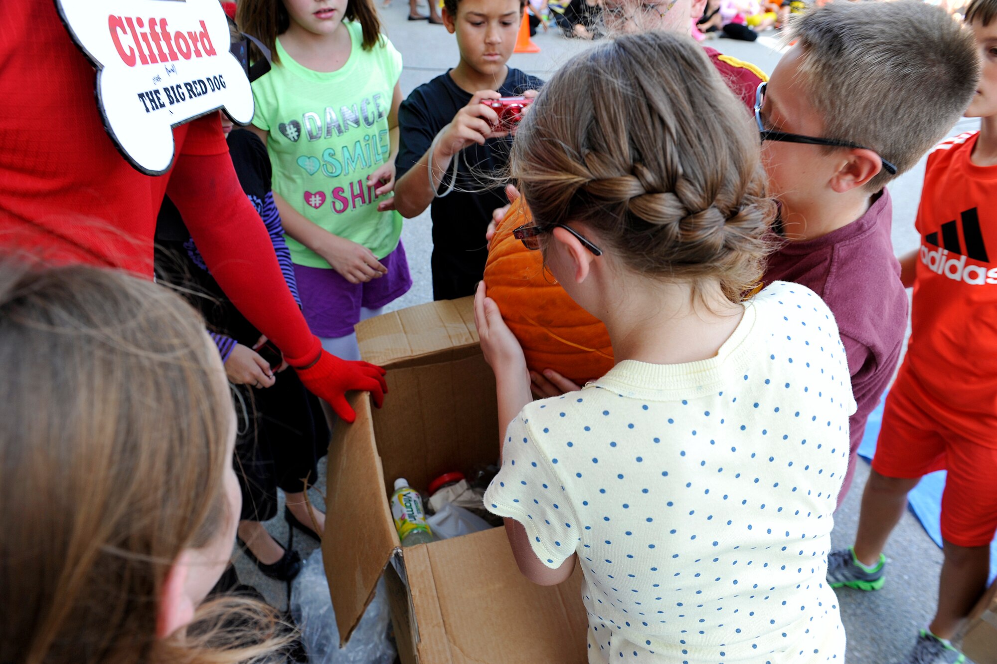 Fifth grade children from Stearley Heights Elementary School check their pumpkin for damage after being dropped from the top of the building Oct. 30, 2015, at Kadena Air Base, Japan. A total of seven teams from the 5th grade participated in the pumpkin drop. (U.S. Air Force photo by Naoto Anazawa)  