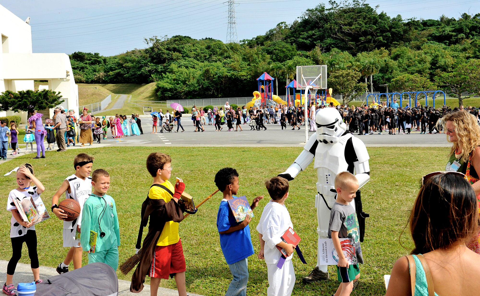 Approximately 500 children from Stearley Heights Elementary School walk as their favorite storybook characters in a school parade Oct. 30, 2015, at Kadena Air Base, Japan. Children from kindergarten to 5th grade participated in the event to celebrate the benefits of reading and writing. (U.S. Air Force photo by Naoto Anazawa)