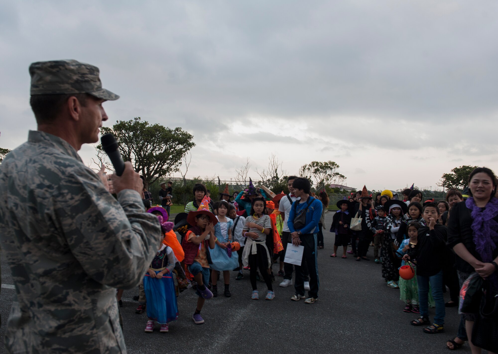 U.S. Air Force Brig. Gen. Barry Cornish, 18th Wing commander, speaks to local Okinawan families Oct. 31, 2015, at Kadena Air Base, Japan. Cornish welcomed the locals to the base and taught them the famous Halloween saying of “trick-or-treat” when seeking holiday treats. (U.S. Air Force photo by Airman 1st Class Lynette M. Rolen)