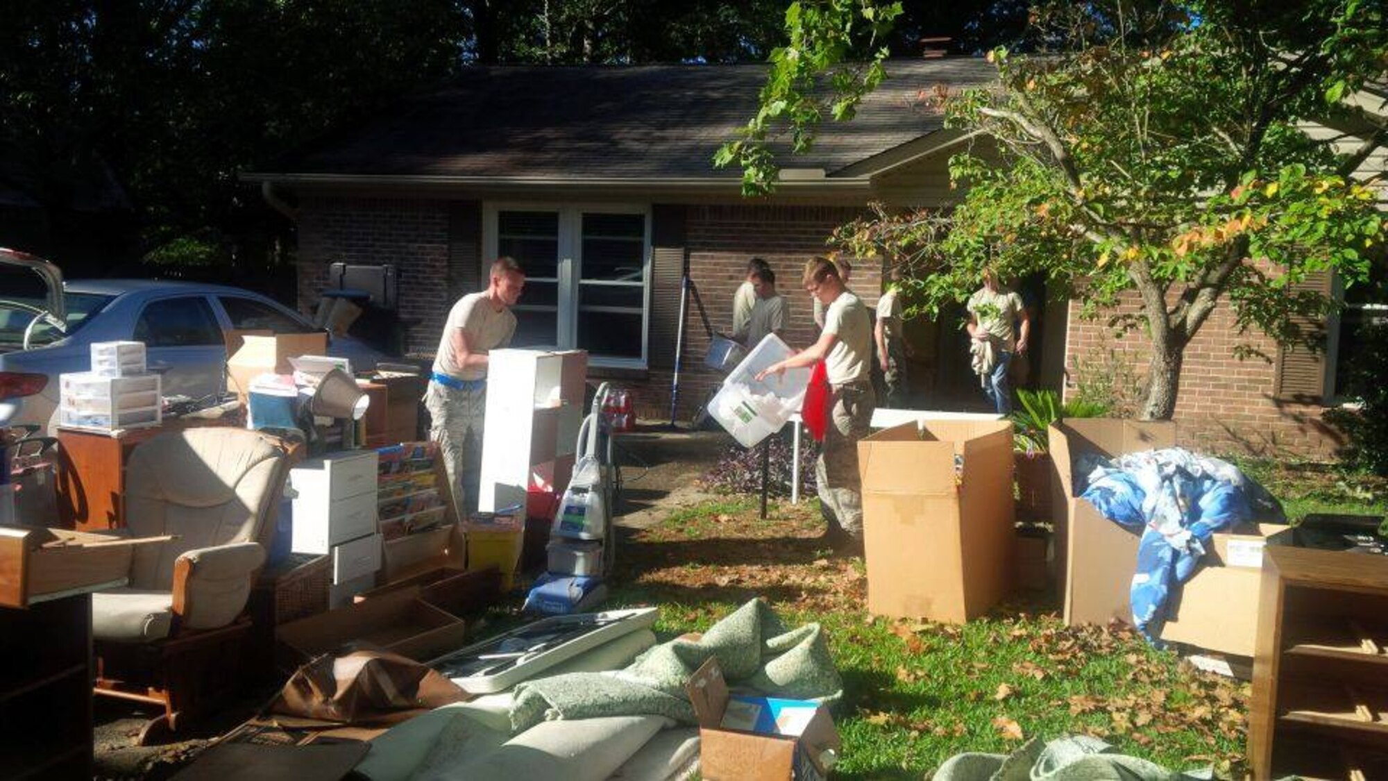 U.S. Airmen and family members from the 169th Fighter Wing, South Carolina Air National Guard, volunteer to provide assistance to residents in a Columbia neighborhood with the removal of household debris Oct. 8, 2015. The South Carolina National Guard has been activated to support state and county emergency management agencies and local first responders as historic flooding impacts counties statewide. Currently, more than 2,900 South Carolina National Guard members have been activated in response to the floods. (U.S. Air National Guard courtesy photo/Released)